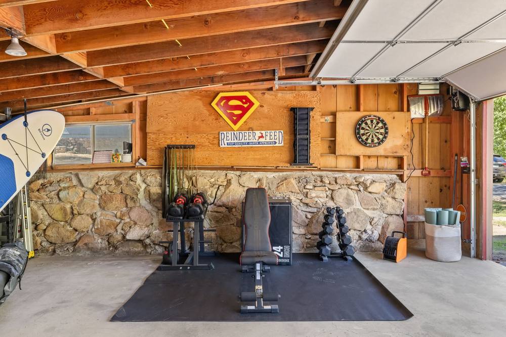 Garage gym with weights and dartboard