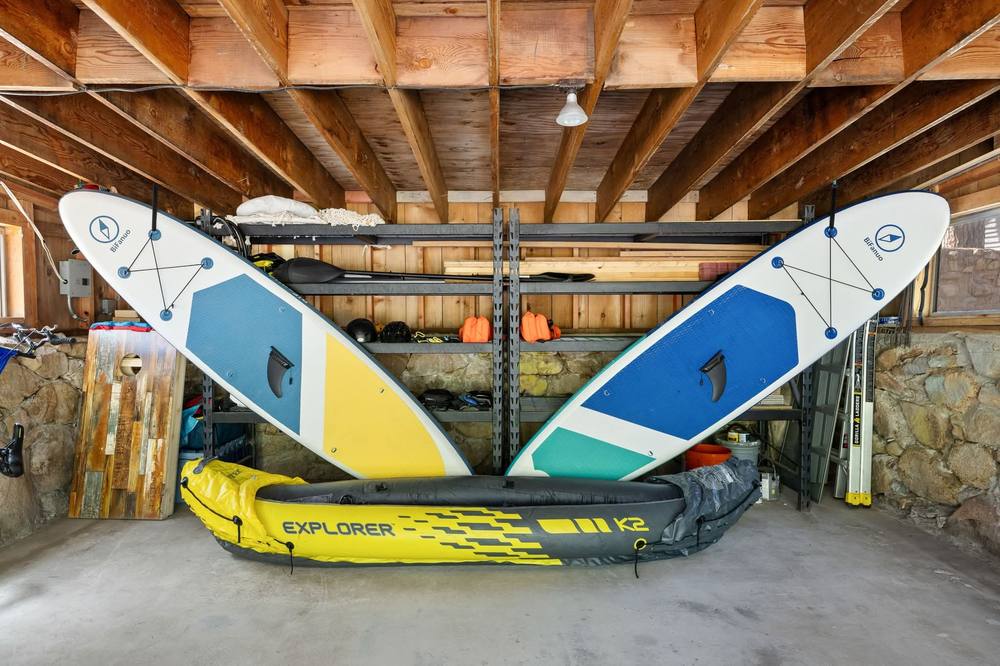 Paddleboards and kayak in the garage